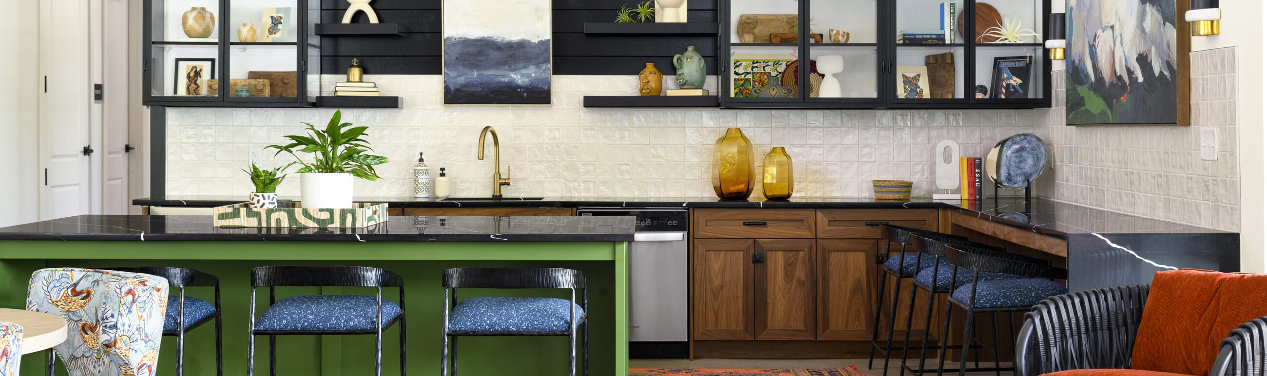 a modern kitchen with black countertops and cabinets