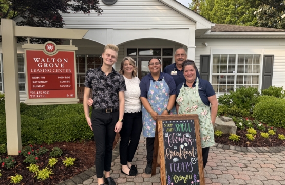 a group standing by the Walton Grove leasing center
