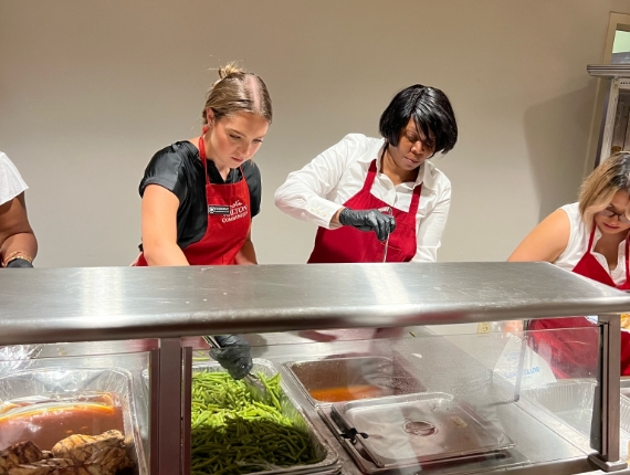 members of the Walton Communities team serving food